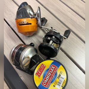 3 fishing reels and one roll of fishing line